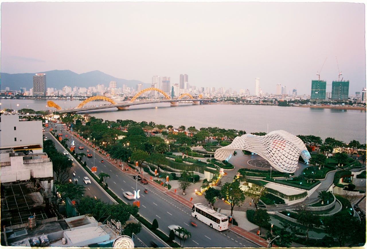 Scenic aerial view of Đà Nẵng cityscape featuring the iconic Dragon Bridge and river.